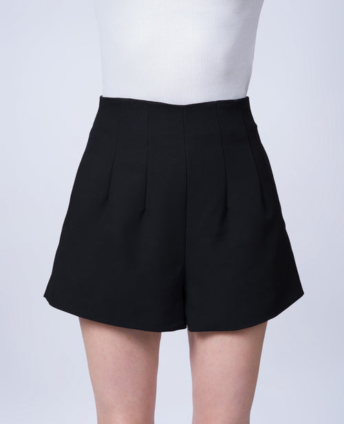 Women’s high-waisted black tailored shorts in a breathable Tencel blend. Front view showcasing the flattering silhouette, tailored construction and contemporary design. Made in Singapore and individually finished by hand.